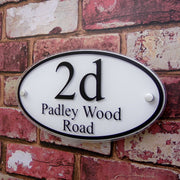 A white oval Number Plaque - House Sign Solutions