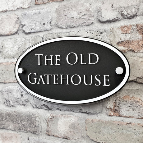 Anthracite grey oval house name plaque thats says 'The Old Gatehouse'
