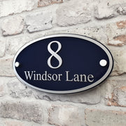 Blue and silver oval house sign 